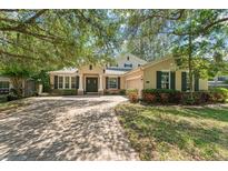 Charming home featuring brick driveway, manicured lawn, double doors and a two car garage at 2827 Park Meadow Dr, Apopka, FL 32703