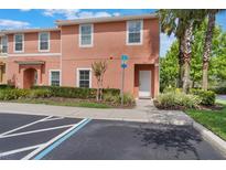 Inviting two-story townhome features an accessible entrance and well-maintained landscaping at 3001 Red Ginger Rd, Kissimmee, FL 34747