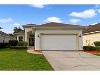 Charming single-story home featuring a well-manicured lawn and a spacious two-car garage at 4558 Redmond Pl, Sanford, FL 32771