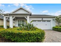 Charming single-story home featuring a well-manicured lawn and a bright white garage door at 5013 E Fountainwood Dr, St Cloud, FL 34772