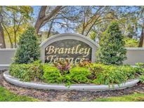 Brantley Terrace community sign surrounded by manicured landscaping provides a welcoming entrance at 581 Brantley Terrace Way # 302, Altamonte Springs, FL 32714