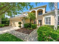 Stunning two-story home features a lush lawn, beautiful landscaping, and a two car garage at 10160 Mallard Landings Way, Orlando, FL 32832