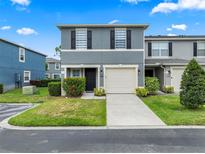 Charming two-story townhome with a one car garage and well-maintained landscaping at 12661 Somerset Oaks St, Orlando, FL 32828