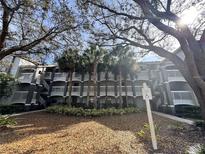 Condo building featuring multiple stories with balconies and a well-maintained landscape at 14025 Fairway Island Dr # 335, Orlando, FL 32837