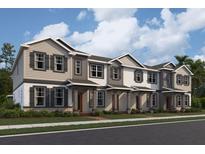 New construction townhomes feature a welcoming entry and charming architectural details, perfect for modern living at 1407 Mount Royal Dr, St Cloud, FL 34771