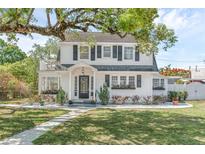 Charming two-story home with a well-manicured lawn and lovely landscaping at 1901 10Th St, St Cloud, FL 34769