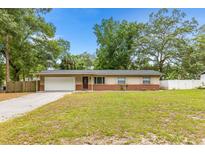 Charming single-story home with a well-manicured front yard and attached garage, perfect for suburban living at 2312 Ne 32Nd Pl, Ocala, FL 34479