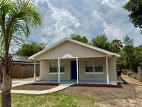 Charming single-story home featuring a covered front porch and a well-maintained lawn with fresh landscaping at 404 S Salisbury Ave, Deland, FL 32720
