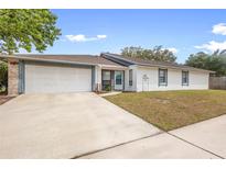 Charming single-story home features a two-car garage, neutral paint, and a well-maintained front yard at 4636 Fern Pine Dr, Orlando, FL 32808