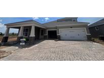 Charming home features a two-car garage, beautiful brick driveway, and a covered porch, blending comfort and curb appeal at 5391 Park Guell St, St Cloud, FL 34771