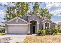 Charming single-story home with a well-manicured lawn and attached two-car garage at 6702 Imperial Oak Ln, Orlando, FL 32819