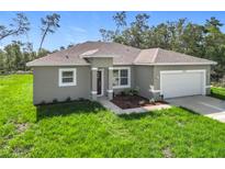 Charming single-story home showcasing manicured lawn and neutral exterior paint at 16253 Sw 29Th Court Rd, Ocala, FL 34473