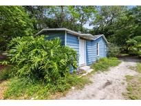 Charming single-story home featuring blue siding and lush greenery at 1701 E Bay St, Winter Garden, FL 34787