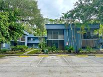 Inviting two-story condo with screened-in balconies and well-maintained landscaping at 2349 Oak Park Way # 107, Orlando, FL 32822