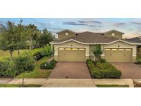 Inviting townhome featuring a brick driveway and well-maintained landscaping at 2362 Datura Loop, St Cloud, FL 34772