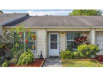 Charming home featuring a well-manicured lawn with beautiful flower beds lining the sidewalk to the front door at 3208 W Tower Ct, Kissimmee, FL 34741