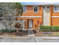 Charming townhouse with a well-maintained exterior, lush landscaping, and dedicated parking at 46 Silver Falls Cir, Kissimmee, FL 34743