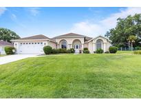 Charming single Gathering home with a well-manicured lawn and an attached two car garage in a quiet neighborhood at 5076 Nw 21St Loop, Ocala, FL 34482
