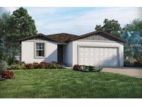 Charming single-story home featuring a two-car garage and beautifully landscaped front yard at 523 Tortugas St, Haines City, FL 33844