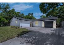 Charming single-story home with a fresh white painted brick and a well-manicured lawn at 7813 Delphia St, Orlando, FL 32807