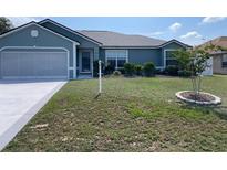 Charming single-story home boasts a well-manicured lawn, mature landscaping, and a two-car garage at 8187 Sw 60Th Ter, Ocala, FL 34476