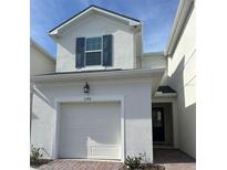 Charming two-story home featuring a one car garage and a welcoming front entrance at 1190 Seaside Mist Trl, Kissimmee, FL 34747