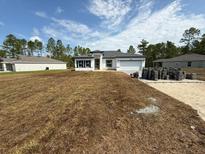 Charming single-story home with a two-car garage and a well-manicured lawn at 13265 Sw 85Th Cir, Ocala, FL 34473