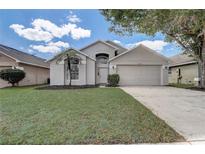 Charming single-Gathering home boasts a well-manicured lawn and two-car garage in a tranquil neighborhood at 19540 Glen Elm Way, Orlando, FL 32833