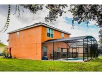 Large fenced-in backyard with a screened-in pool, offering privacy and outdoor enjoyment at 2660 Santosh Cv, Kissimmee, FL 34746