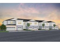 Attractive three-story townhome featuring an attached garage and well-maintained landscaping at 393 Meadowland Pt, Oviedo, FL 32765