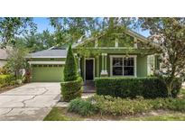 Charming green home with a well-manicured front yard and inviting entryway at 4813 River Gem Ave, Windermere, FL 34786