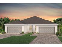 Stylish single story home with a brick paved driveway and a well-manicured green space at 5158 Gardenrow Dr, St Cloud, FL 34772