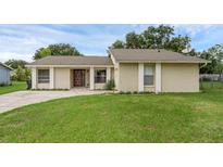 Charming single-story home featuring a well-maintained lawn and welcoming front entrance at 715 Wedge Ln, Poinciana, FL 34759