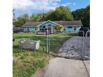 Charming single-story home with a fenced front yard and driveway at 10430 Lehman Rd, Orlando, FL 32825