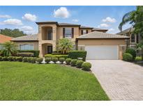Beautiful two-story home boasts manicured landscaping, a paver driveway, and a pristine three-car garage at 108 Sagecrest Dr, Ocoee, FL 34761