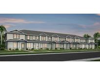 Charming new townhome with lush landscaping and craftsman-style details at 11328 Blue Bay Dr, Orlando, FL 32832