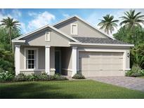 Charming one-story home featuring a two-car garage, well-manicured lawn, and stylish architectural details at 2112 Antilles Club Dr # 8, Kissimmee, FL 34747