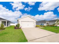 Charming single-Gathering home features a two-car garage and well-maintained lawn at 2226 Majestic Span Ave, Eagle Lake, FL 33839