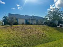 Inviting single-story home featuring blue shutters and a well-maintained front lawn at 3123 Tamarind Dr, Edgewater, FL 32141