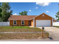 Charming single-story home with a well-manicured lawn and a two-car garage, perfect for suburban living at 7616 Southwick St, Orlando, FL 32818