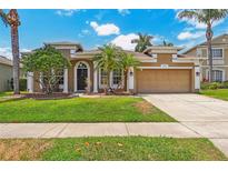 Well-maintained home with a two-car garage, beautiful landscaping, and a freshly manicured lawn at 10161 Sandy Marsh Ln, Orlando, FL 32832