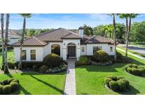 Inviting single-story home with manicured landscaping and a paver walkway leading to the front door at 11706 Waterstone Loop Dr, Windermere, FL 34786