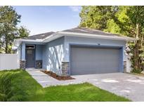 Charming one-story home with attached garage and blue exterior at 1203 W 16Th St, Sanford, FL 32771
