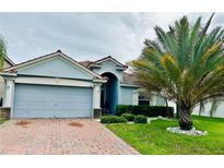 Charming single-story home with a two-car garage and well-manicured front yard at 1474 Lake Side Ave, Davenport, FL 33837
