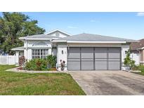 Charming single-Gathering home featuring an attached garage and well-maintained landscaping at 171 Seabreeze Cir, Kissimmee, FL 34743