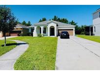 Well-maintained single-story home with a manicured lawn, inviting curb appeal, and a spacious driveway at 1726 Brassie Ct, Kissimmee, FL 34746