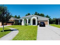 Charming single-story home with a well-manicured lawn, driveway, and attached garage at 1726 Brassie Ct, Kissimmee, FL 34746