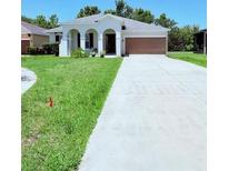 Charming single-story home with well-maintained lawn and long driveway at 1726 Brassie Ct, Kissimmee, FL 34746