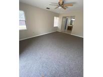 This bedroom features neutral walls, carpeted floors, and a ceiling fan at 1880 N Crystal Lake Dr # 3, Lakeland, FL 33801