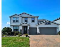 Beautiful two-story home showcasing a two-car garage and meticulously maintained landscaping at 2539 Auburn Ridge Dr, Apopka, FL 32712